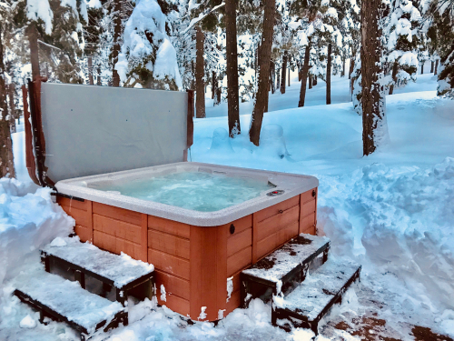 A hot tub surrounded by snow.