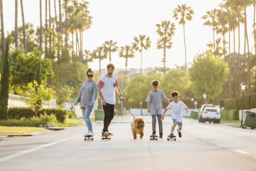family-skating-with-dog