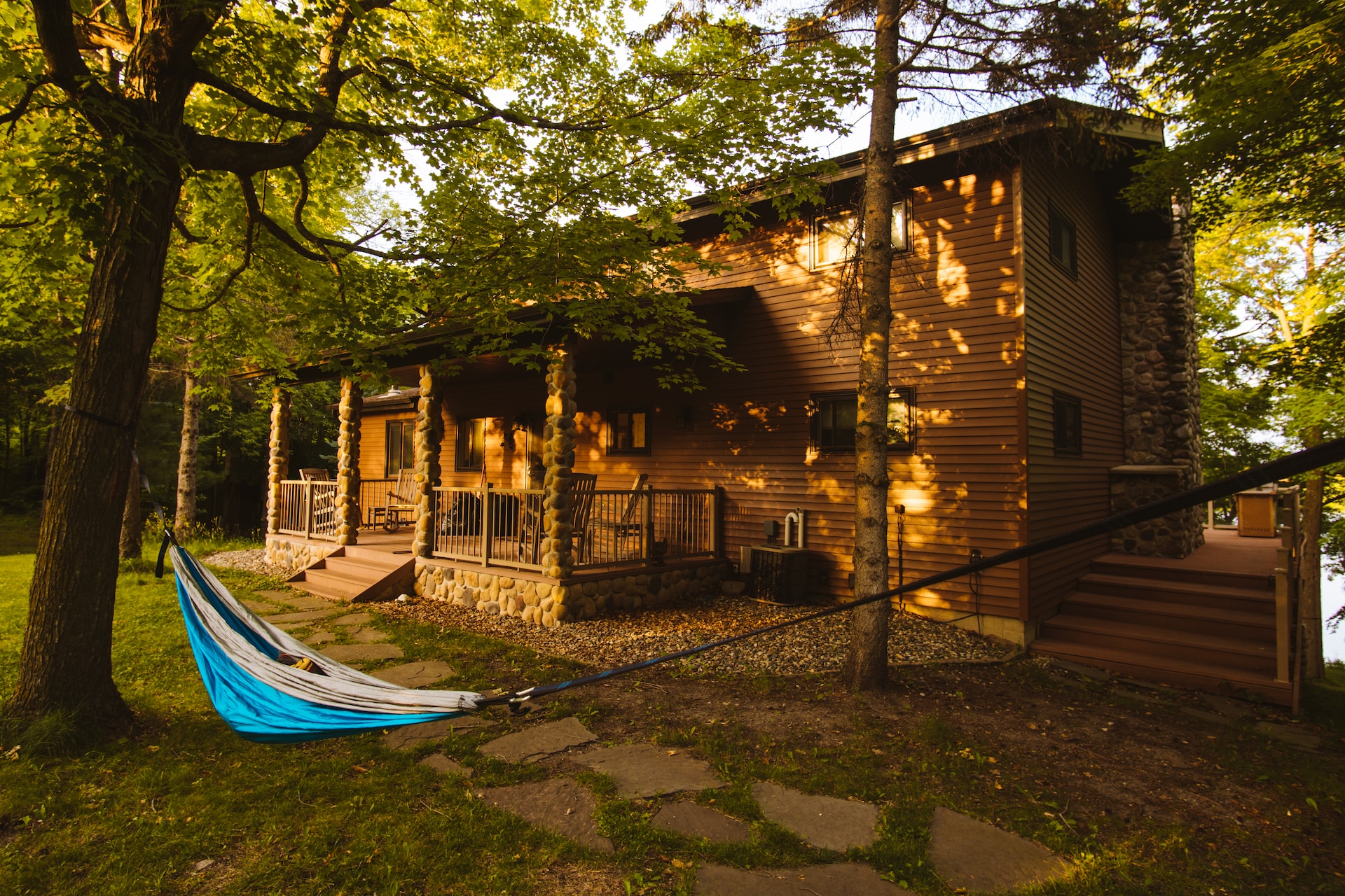 Upscale cabin with a blue hammock out front.