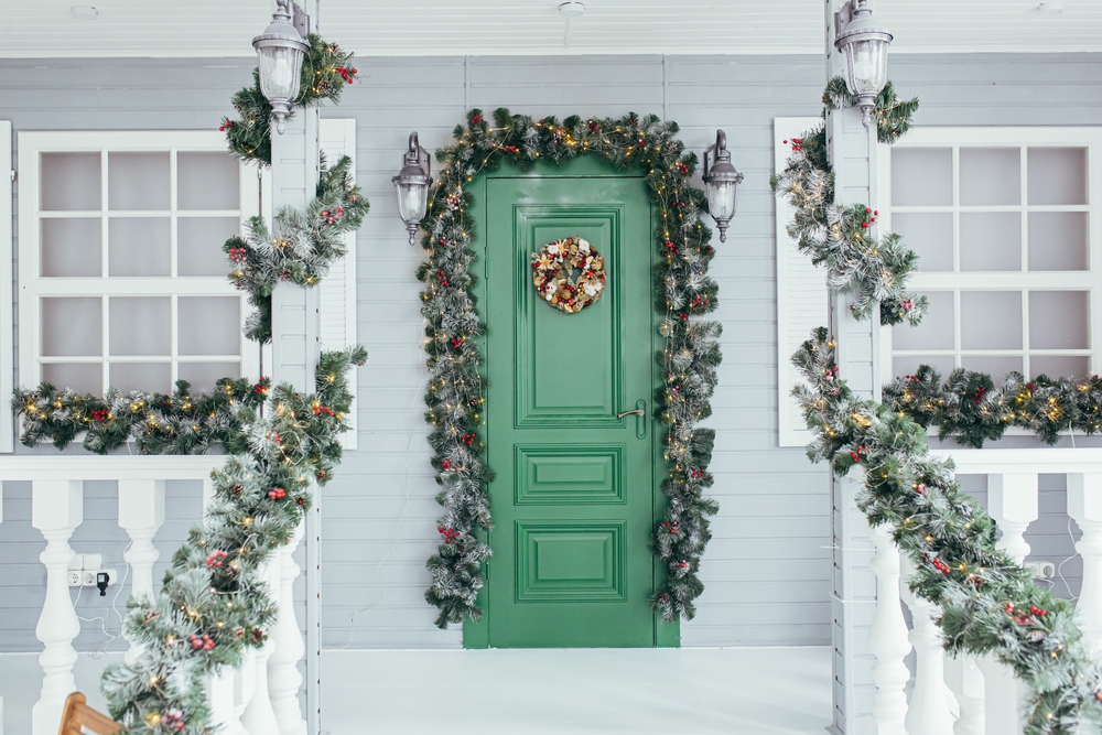 Festively decorated entrance to a house with Christmas decor.