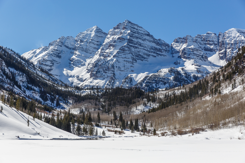 Mountains in Apsen rising above a wooded bowl.