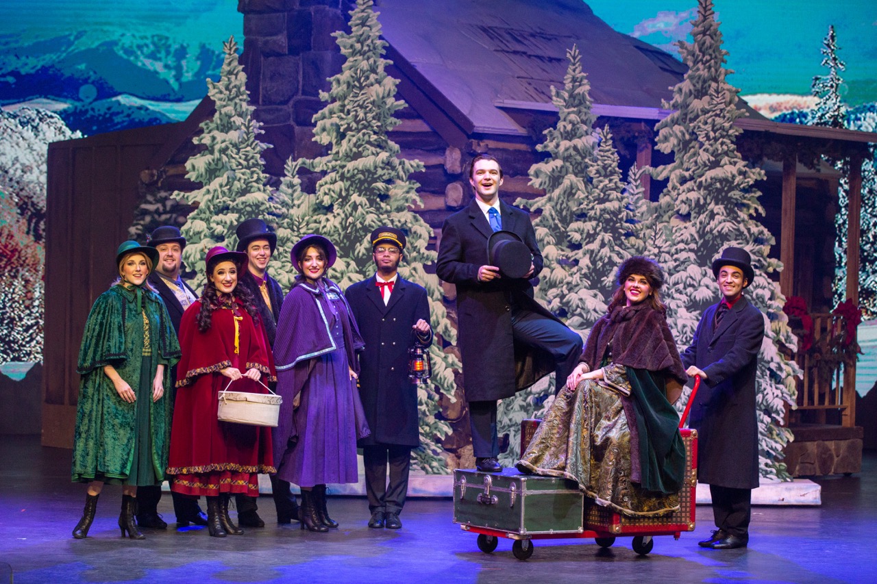 A production of Christmas in the Smokies with a diverse cast on stage.