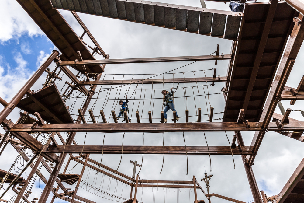 Mother and son together on a challenging obstacle course.