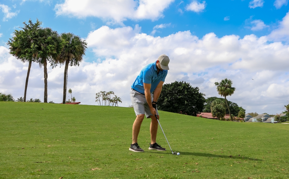 A golfer chipping his second shot.