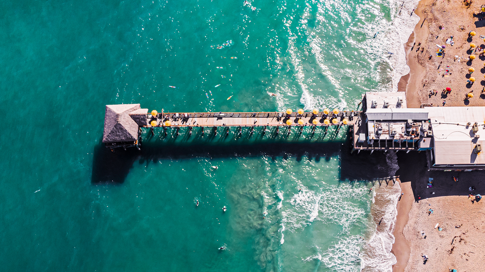 Aerial picture of the Cocoa Beach Pier located in Florida with a blue sea.