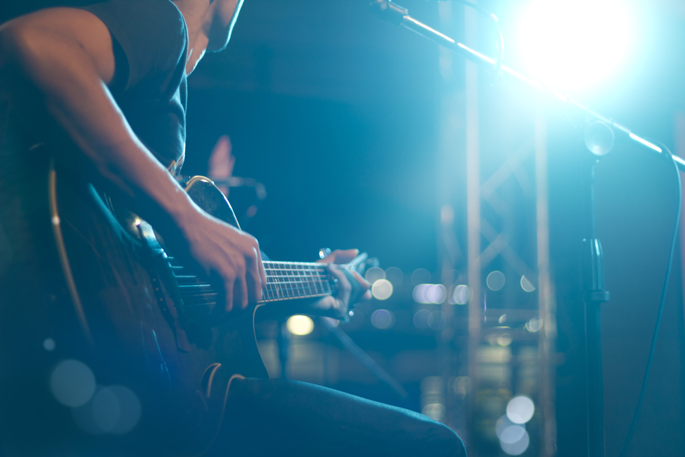 Guitarist on stage for background, soft and blur concept.