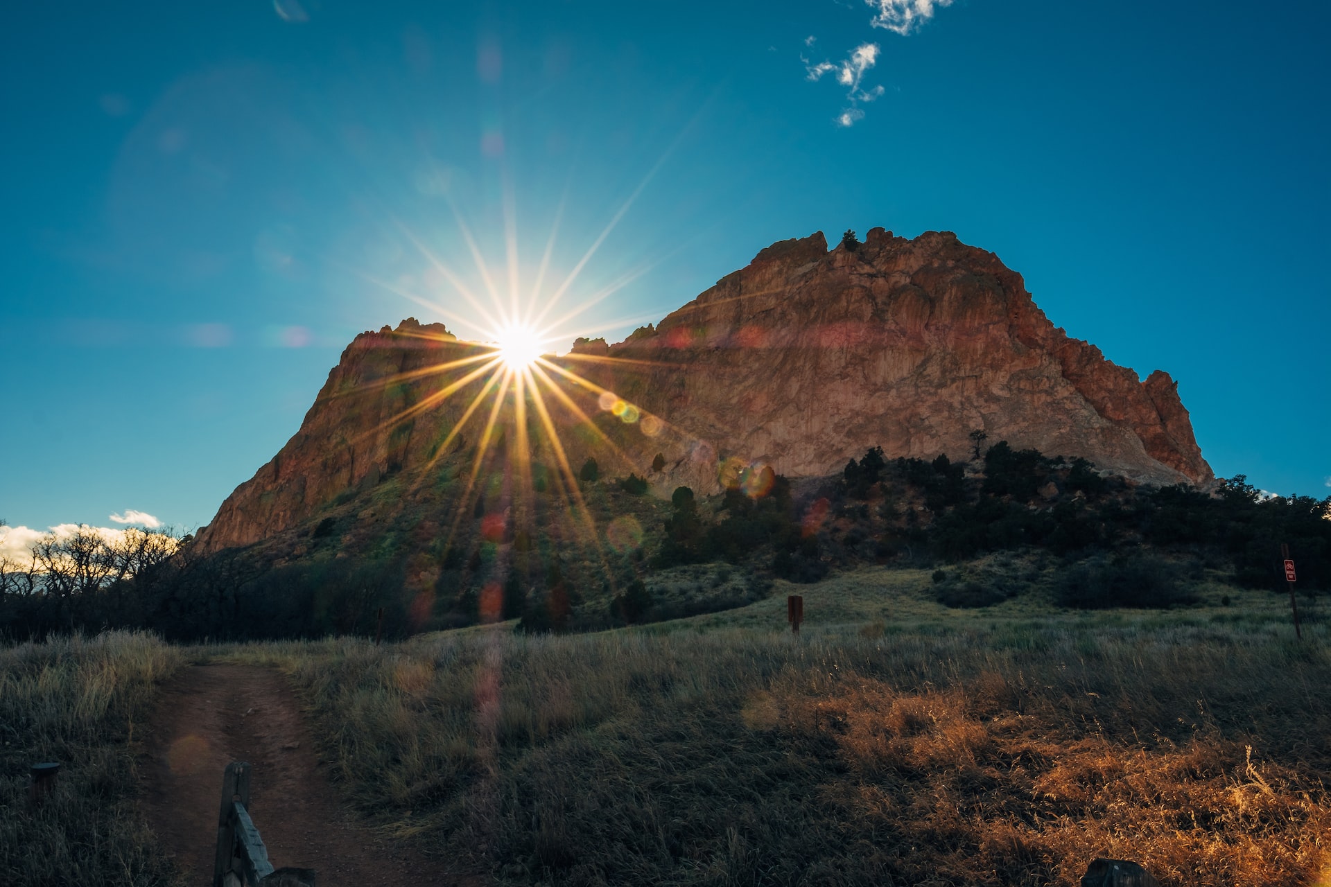 Garden of the Gods with the sun setting behind the mountains.