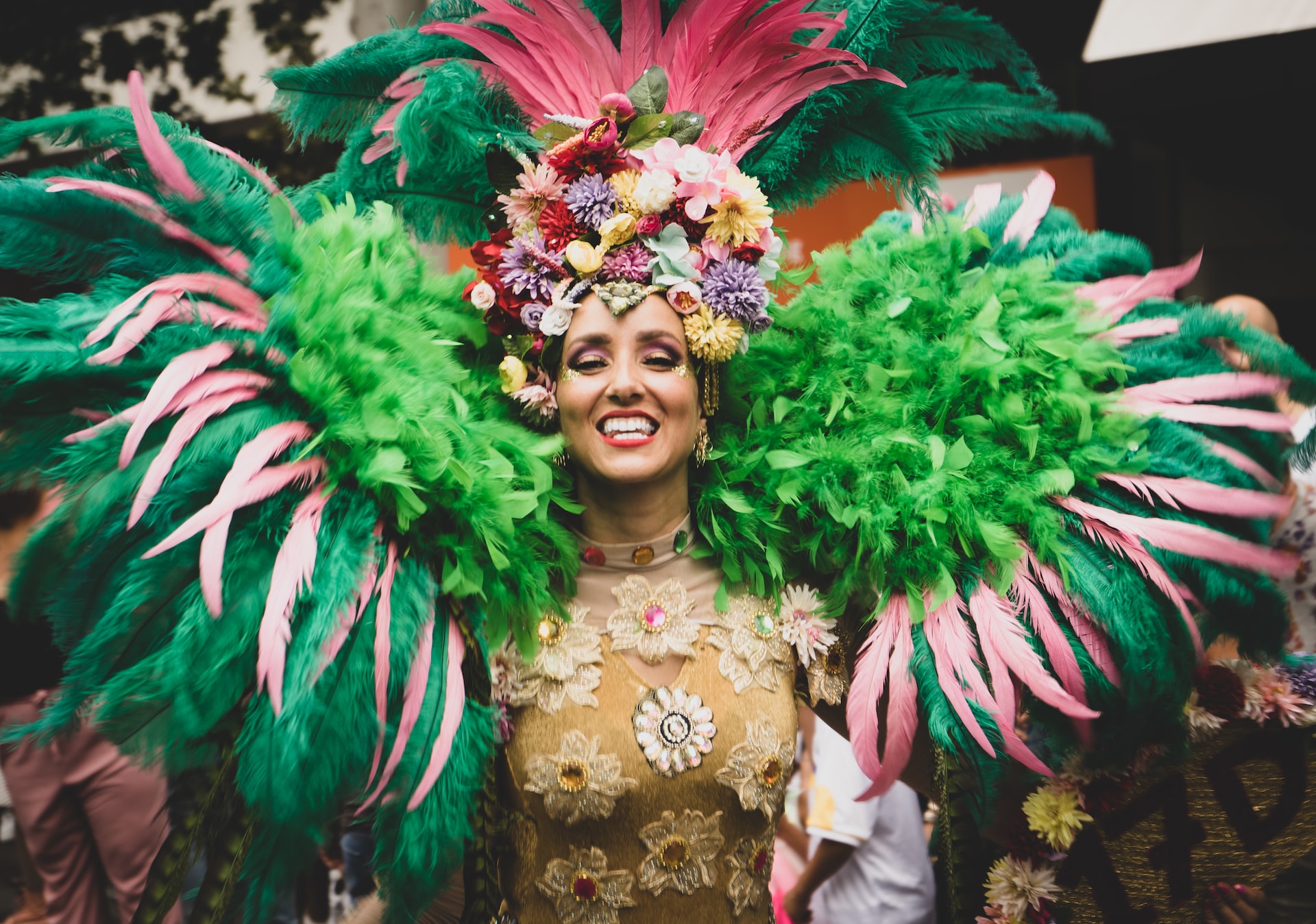 A woman wearing an elaborate feather boa and crown.