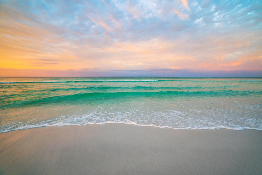 Destin Florida during morning sunrise, the sky the color of peach sherbert.