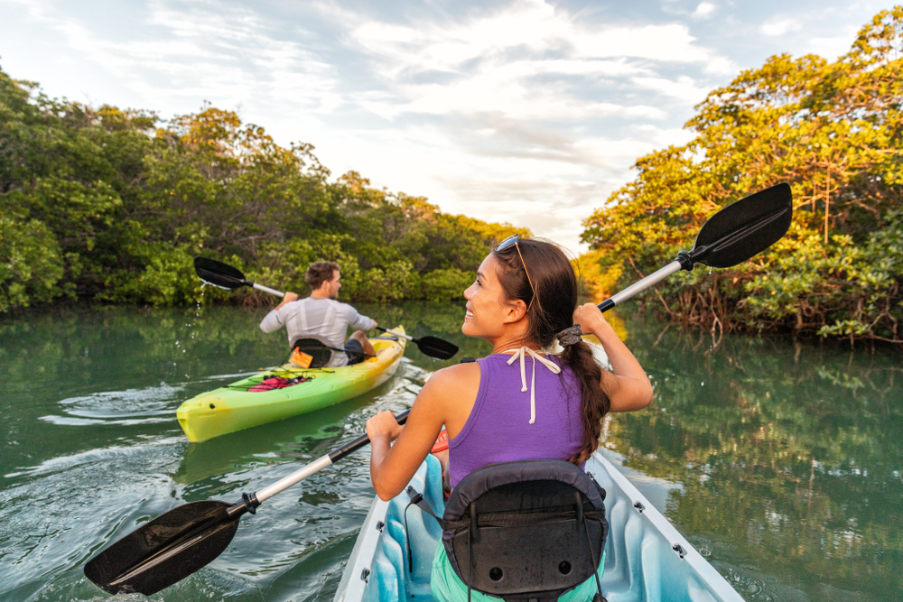 Couple kayaking together in mangrove river of the Keys, Florida.