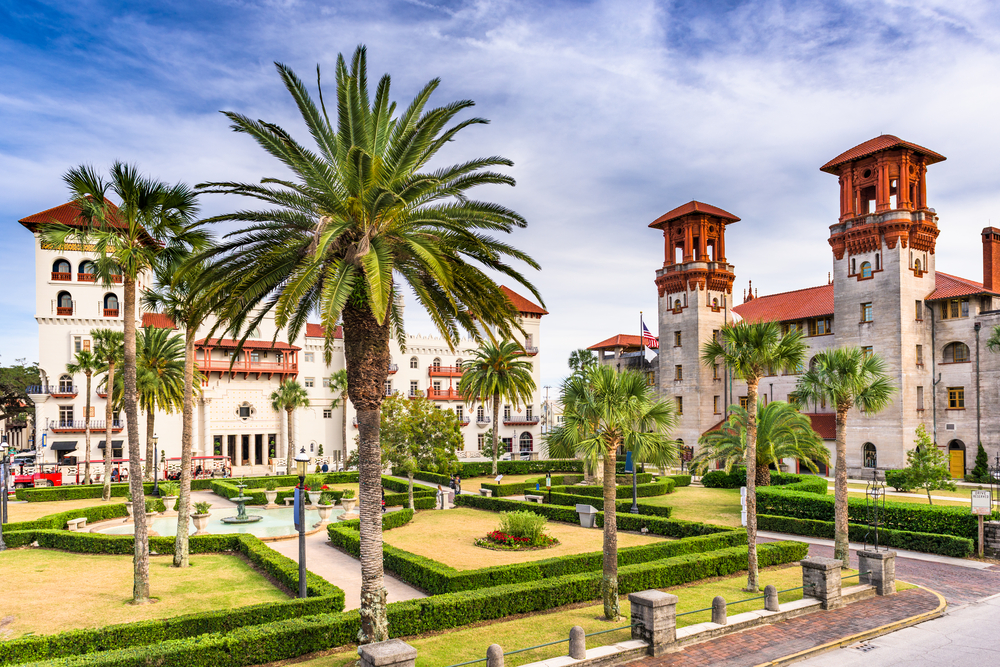 Spanish-style architecture in St. Augustine beside palm trees.