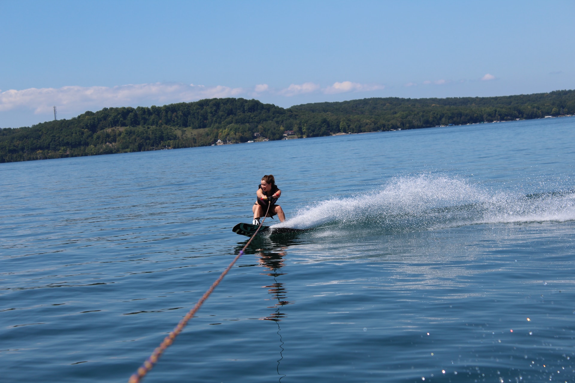 Woman wakeboarding on Torch Lake.