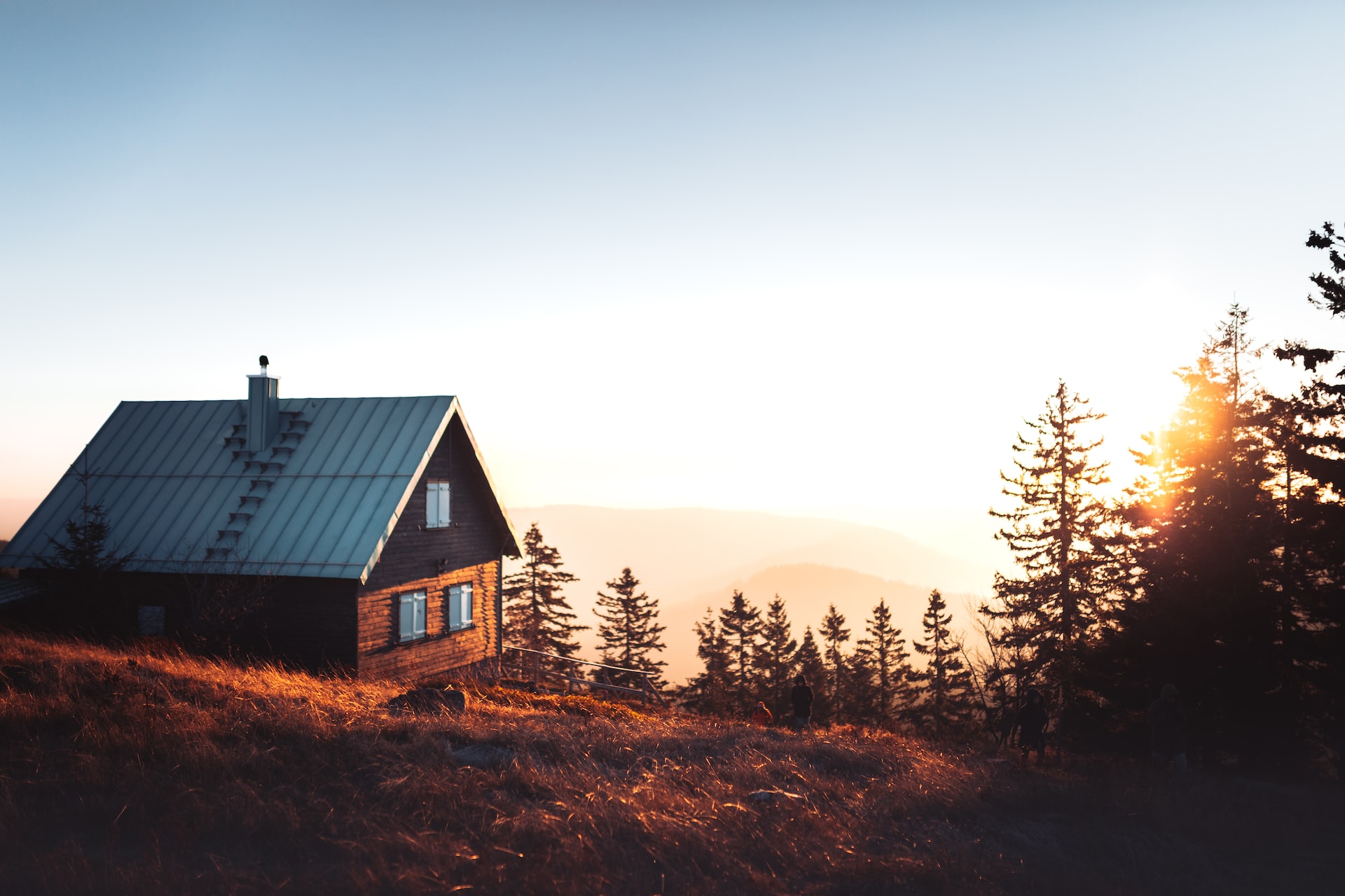 A mountainside cabin bathed in golden light.