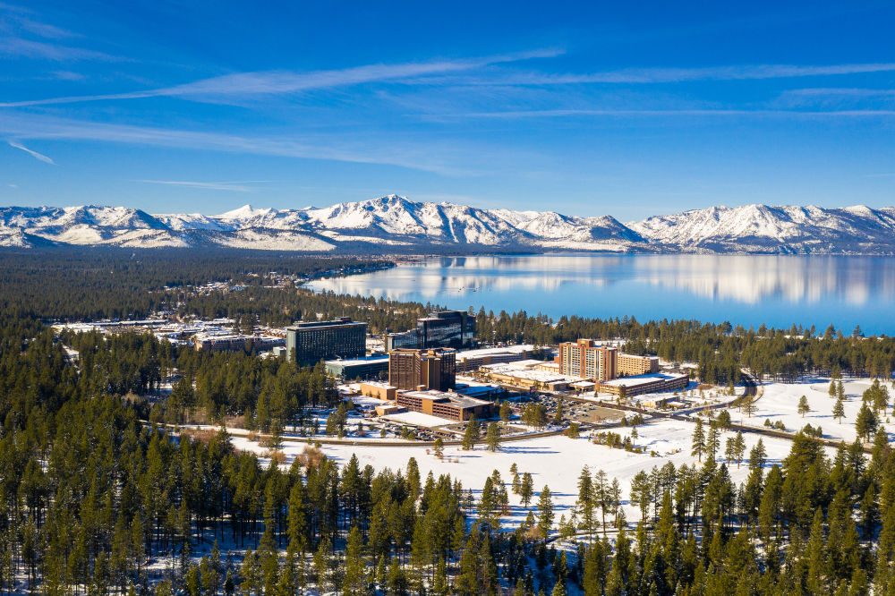 Casinos in Lake Tahoe, snow on ground with snowy mountain peaks in distance.