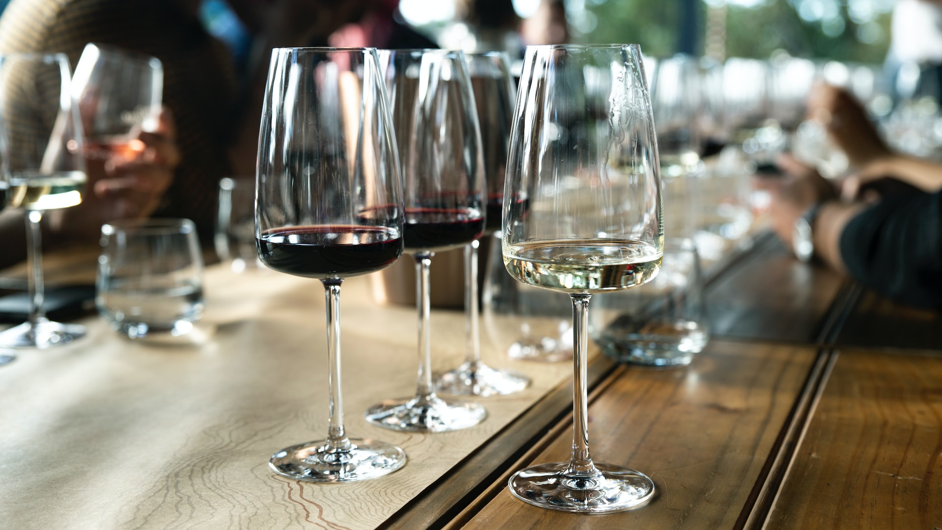 Slender wine glasses at a dinner table.