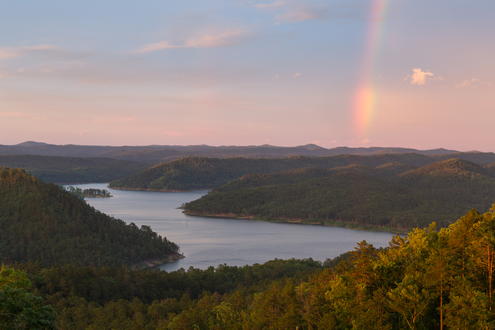 A rainbow in the sky during a beautiful sunset at Broken Bow Lake, Oklahoma.