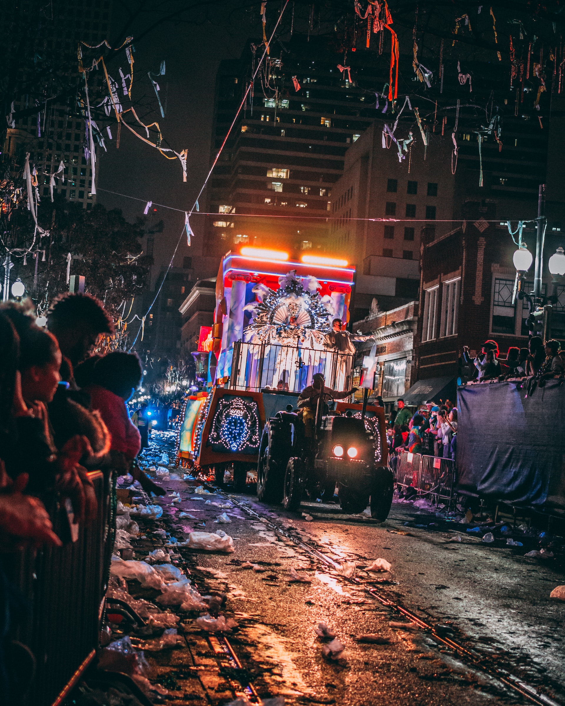 A parade rolls by during Mardi Gras in New Orleans at night.