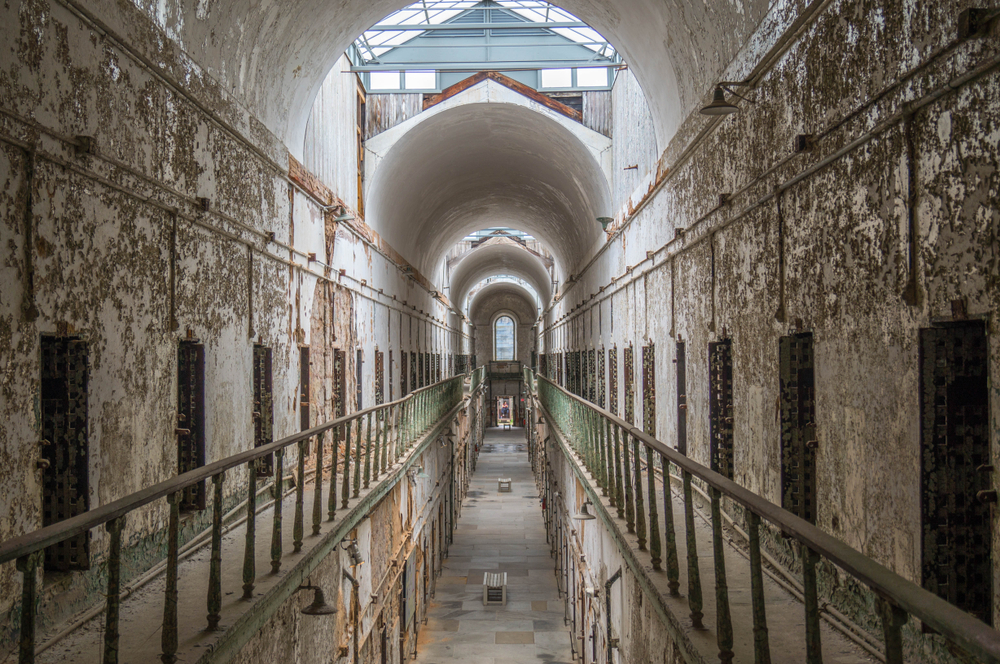A spooky long hallway in Eastern State Penitentiary.