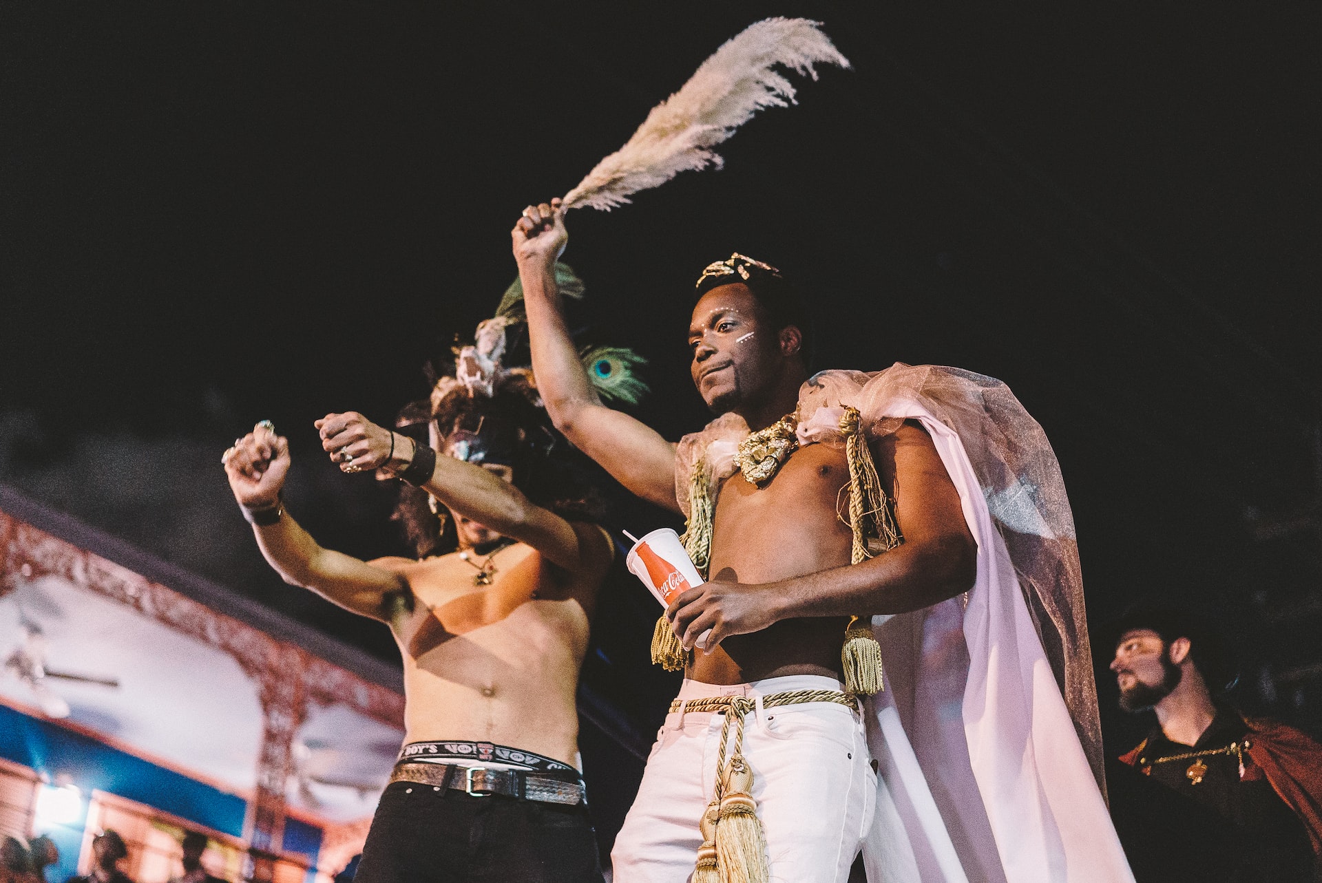 Two men in Carnival attire partying in New Orleans.