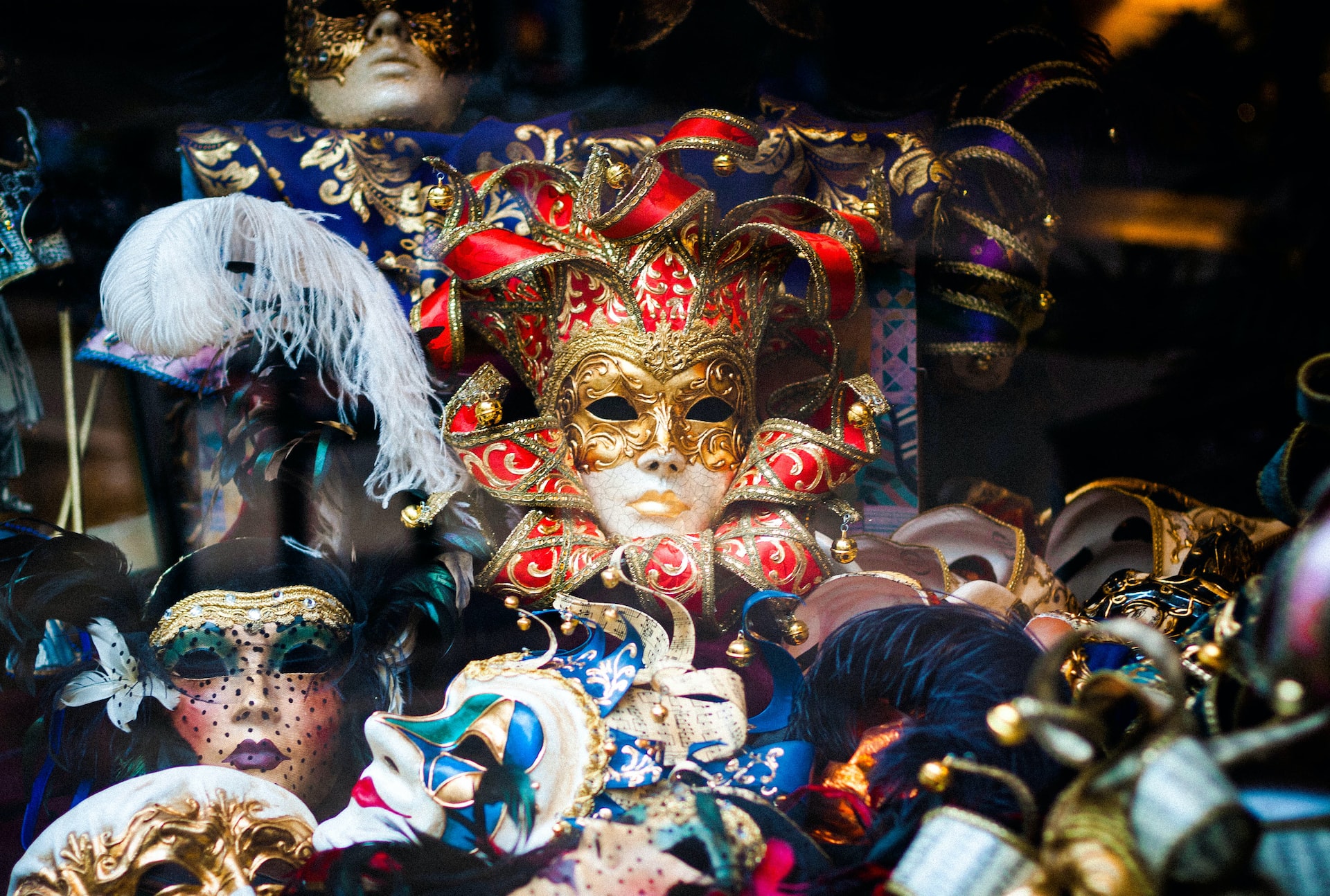 Carnival masks in a storefront window.