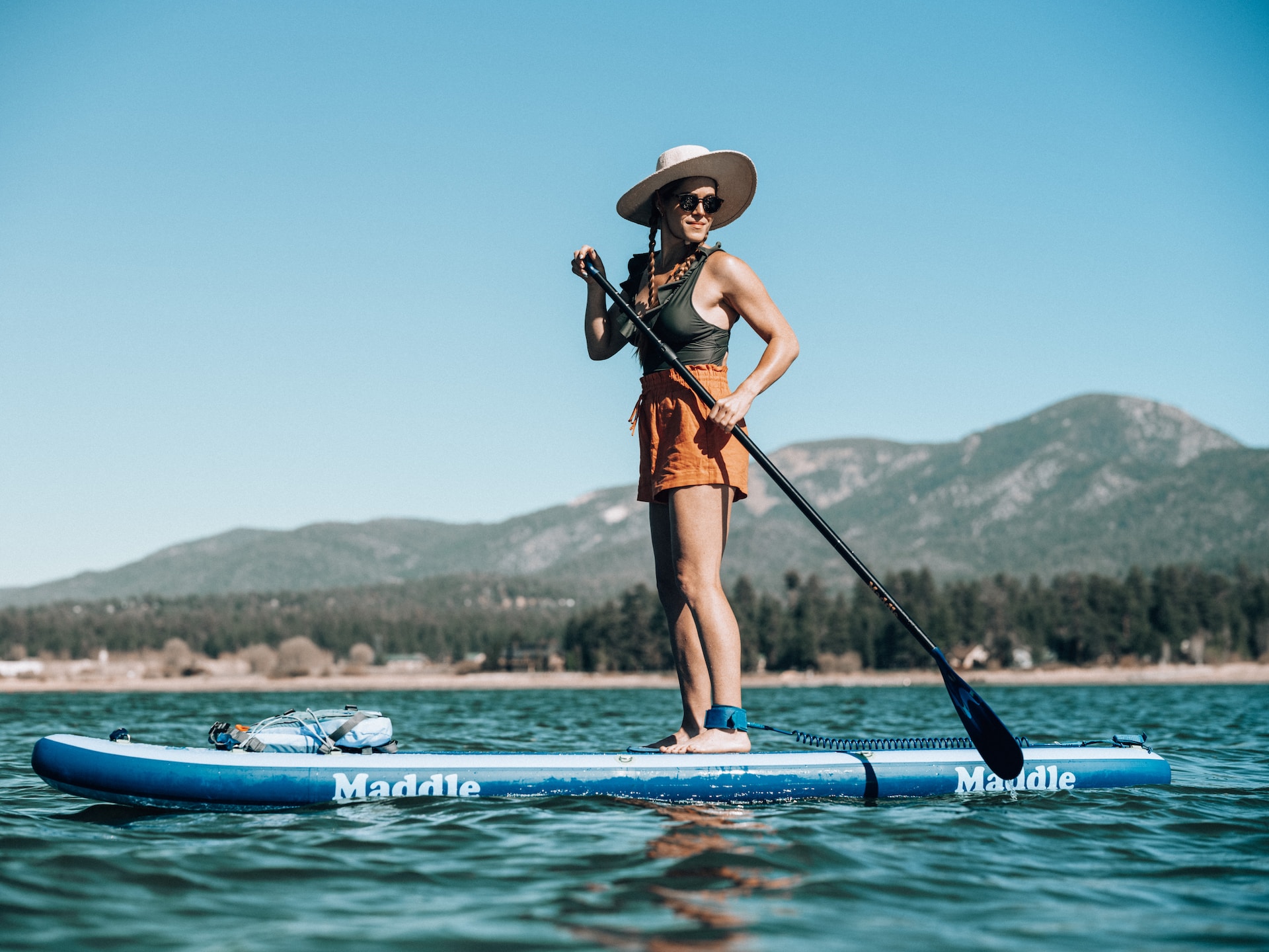 Woman standing on paddleboard on Big Bear Lake.
