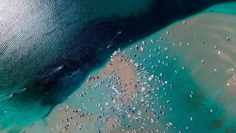 Aerial view of boats anchored along a sandbar.
