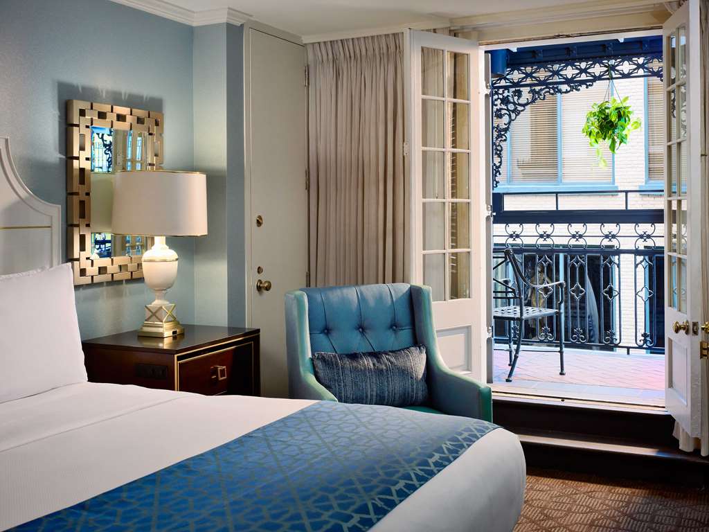 The Royal Sonesta New Orleans hotel with traditional wrought-iron fencing and balcony beside a room.