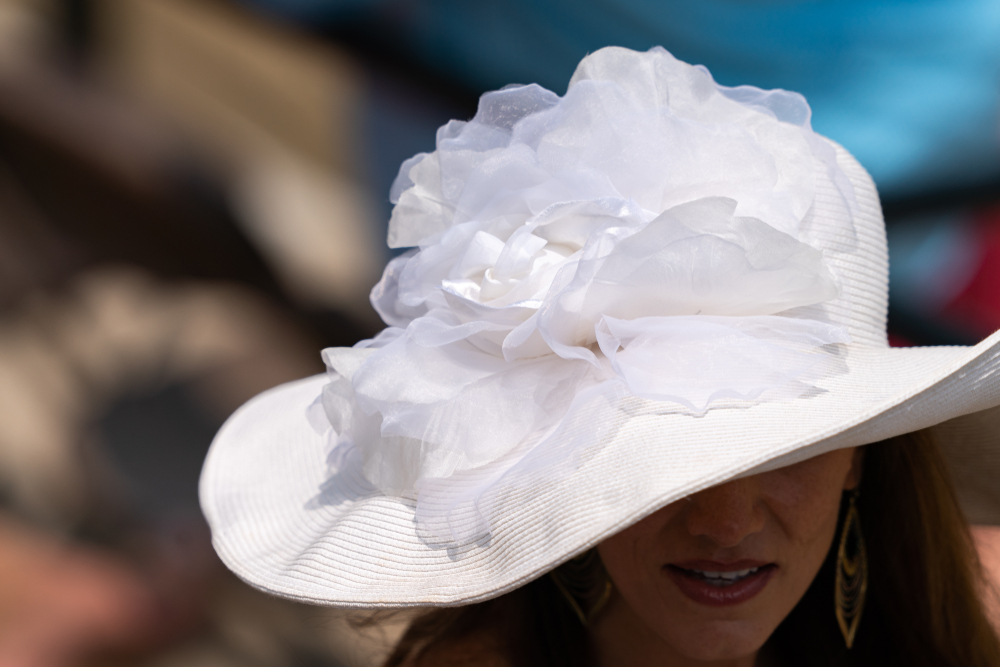 A women wearing an elegant white Derby hat.