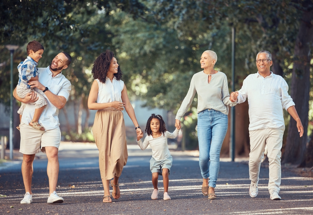 A smiling, happy family walking down the street.