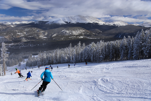 Skiers going down a snowy run in Breckenridge, Colorado.