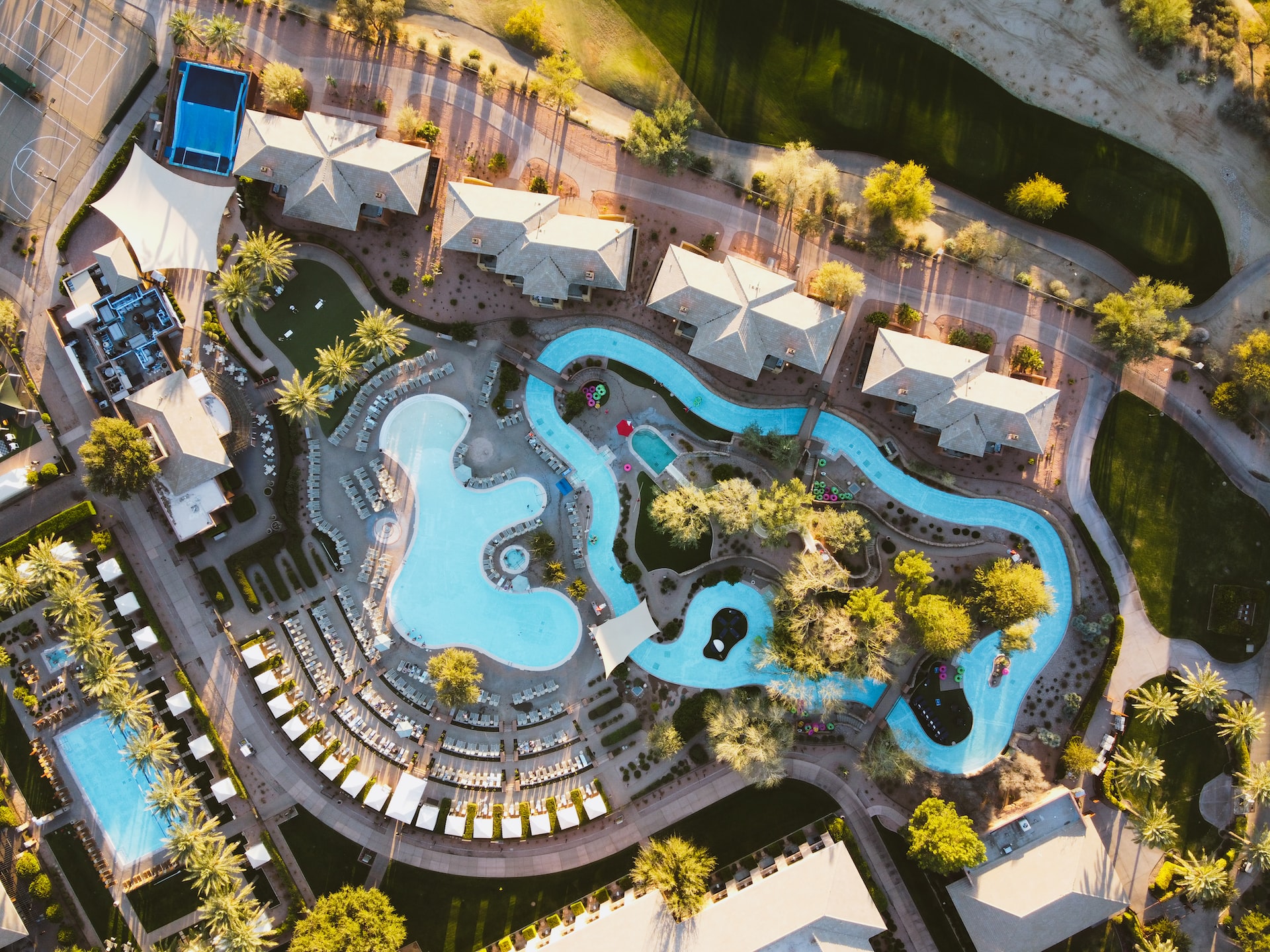 A bird's eye view of a resort in Phoenix with a pool and lazy river.