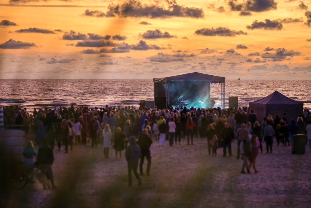 People gathered for a concert on the beach.