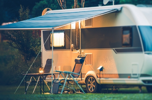 RV-with-awning-and-lawn-chairs