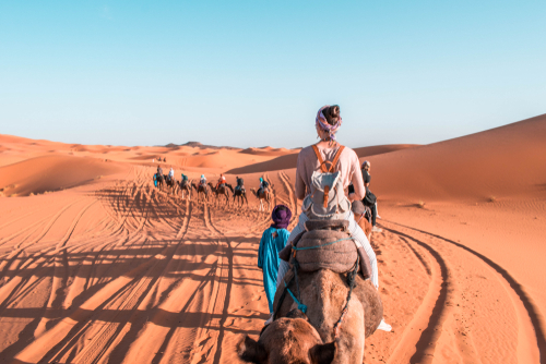 woman-riding-camel-in-desert