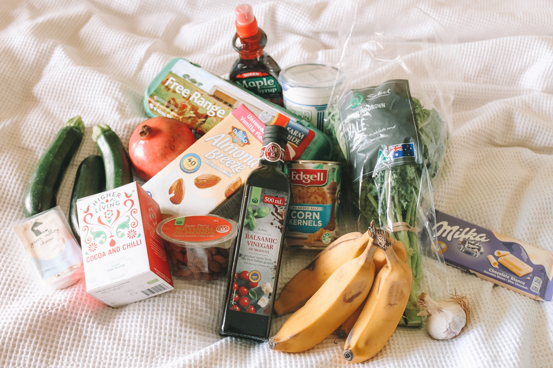 Assorted food laid out on a bed.