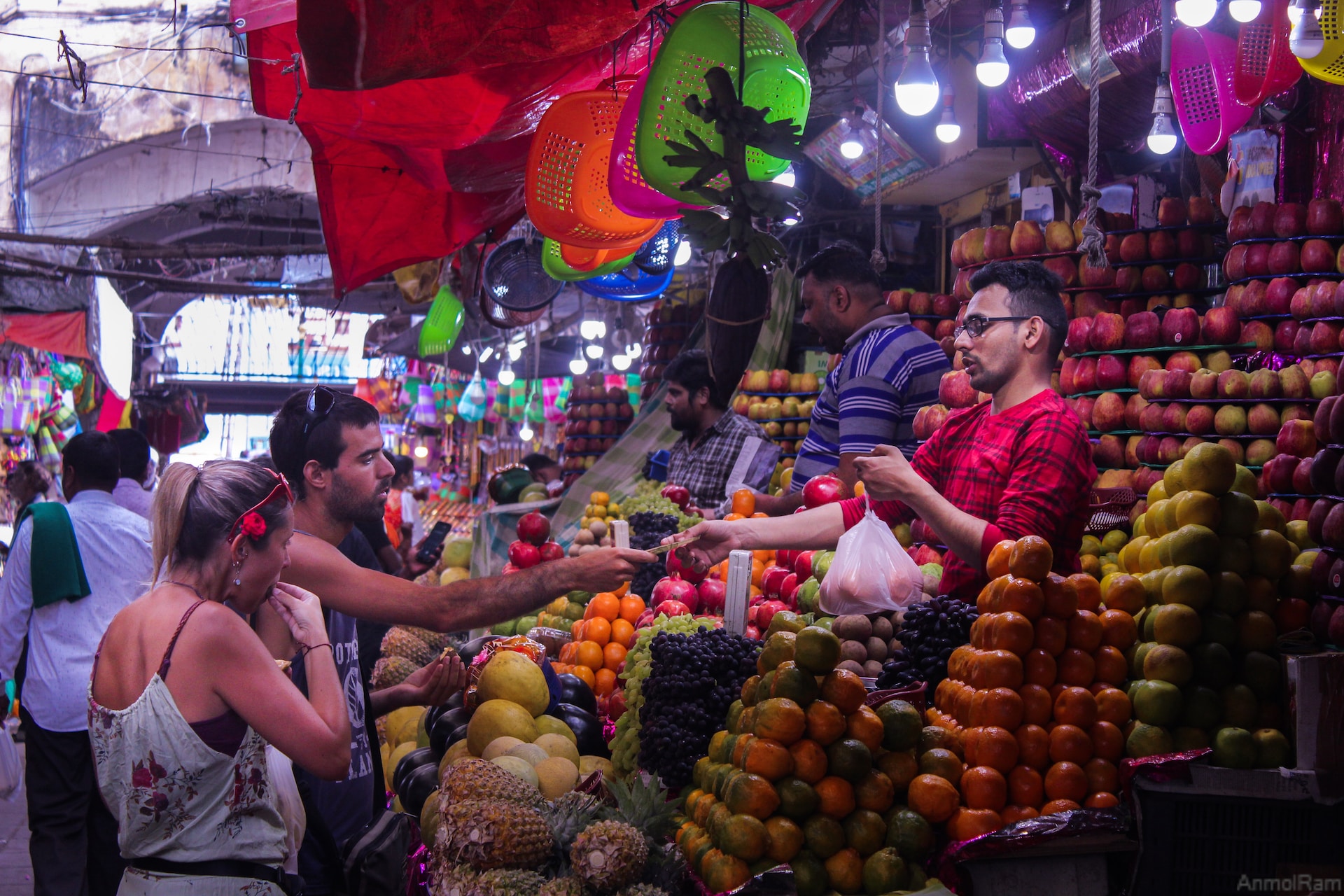 A couple paying for food at a food stand in India. 