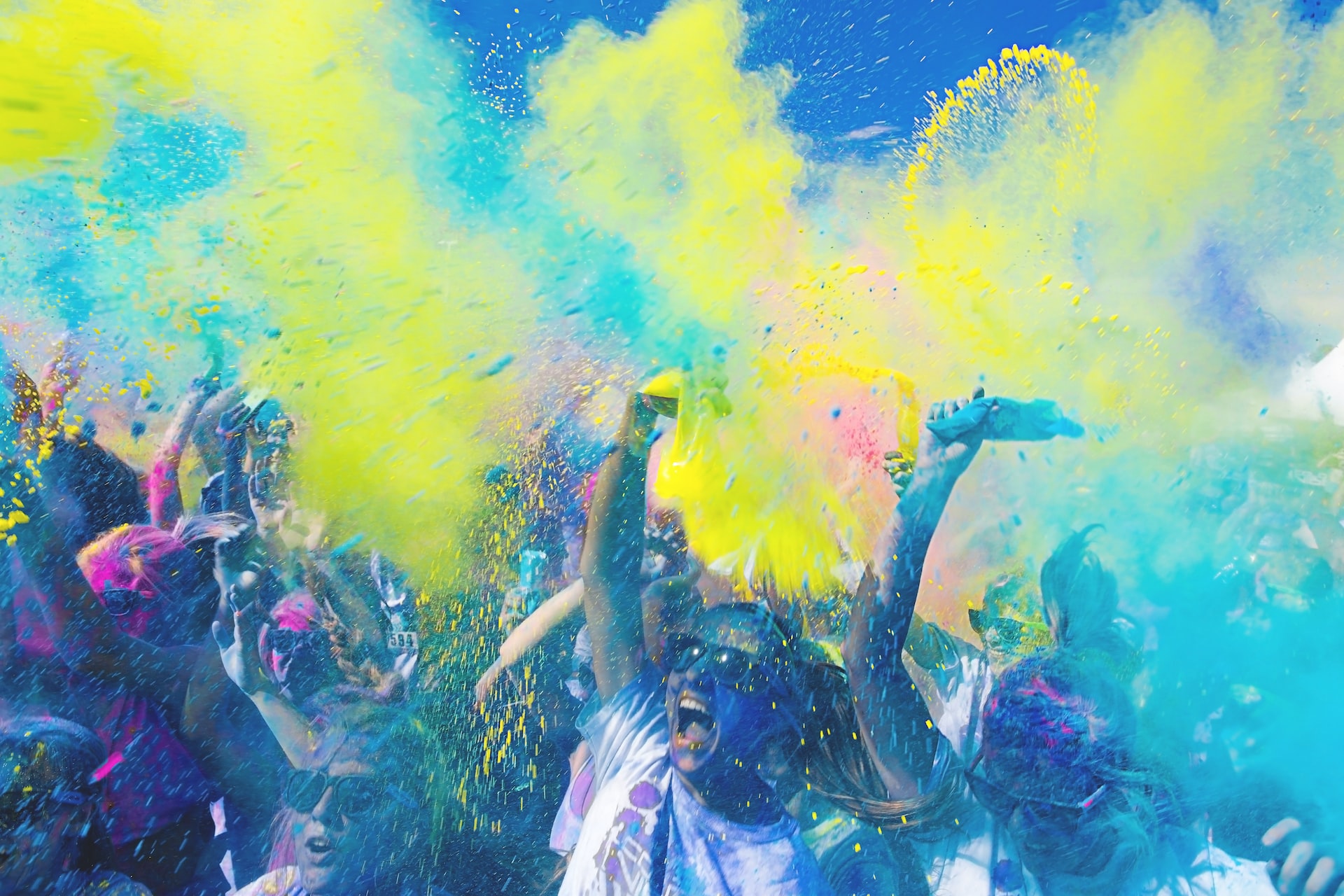 People throwing colorful powder in the air.