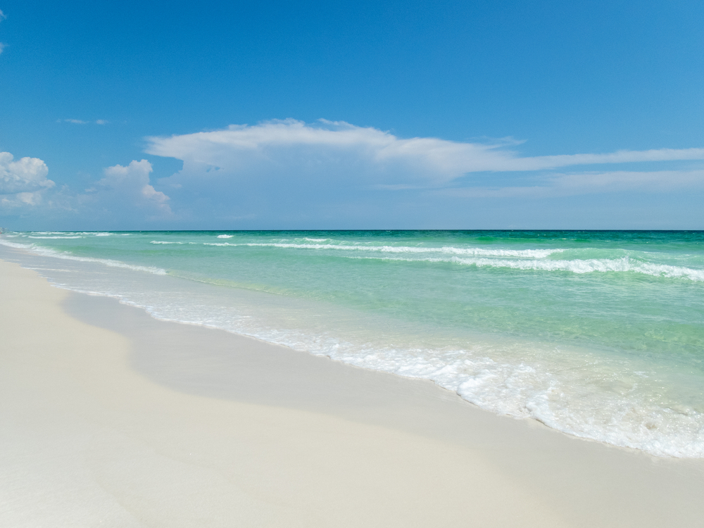 Blue skies, white sands and green waters on Florida’s Emerald Coast near Henderson Beach State Park and Destin Florida.