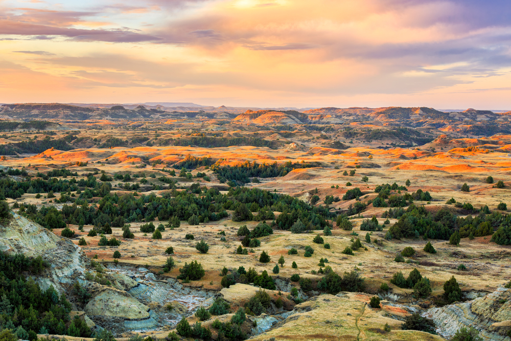 Sunrise over Theodore Roosevelt National Park staining the hills in beautiful vibrant colors in North Dakota.