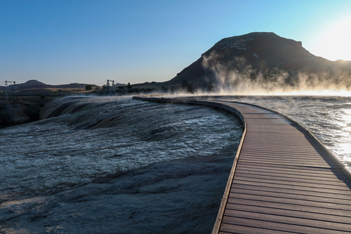 Heat rising off the hot water in the morning with a boardwalk crossing the hot springs in Thermopolis.