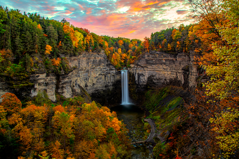 The captivating Taughannock Falls at sunset during peak fall foliage colors.