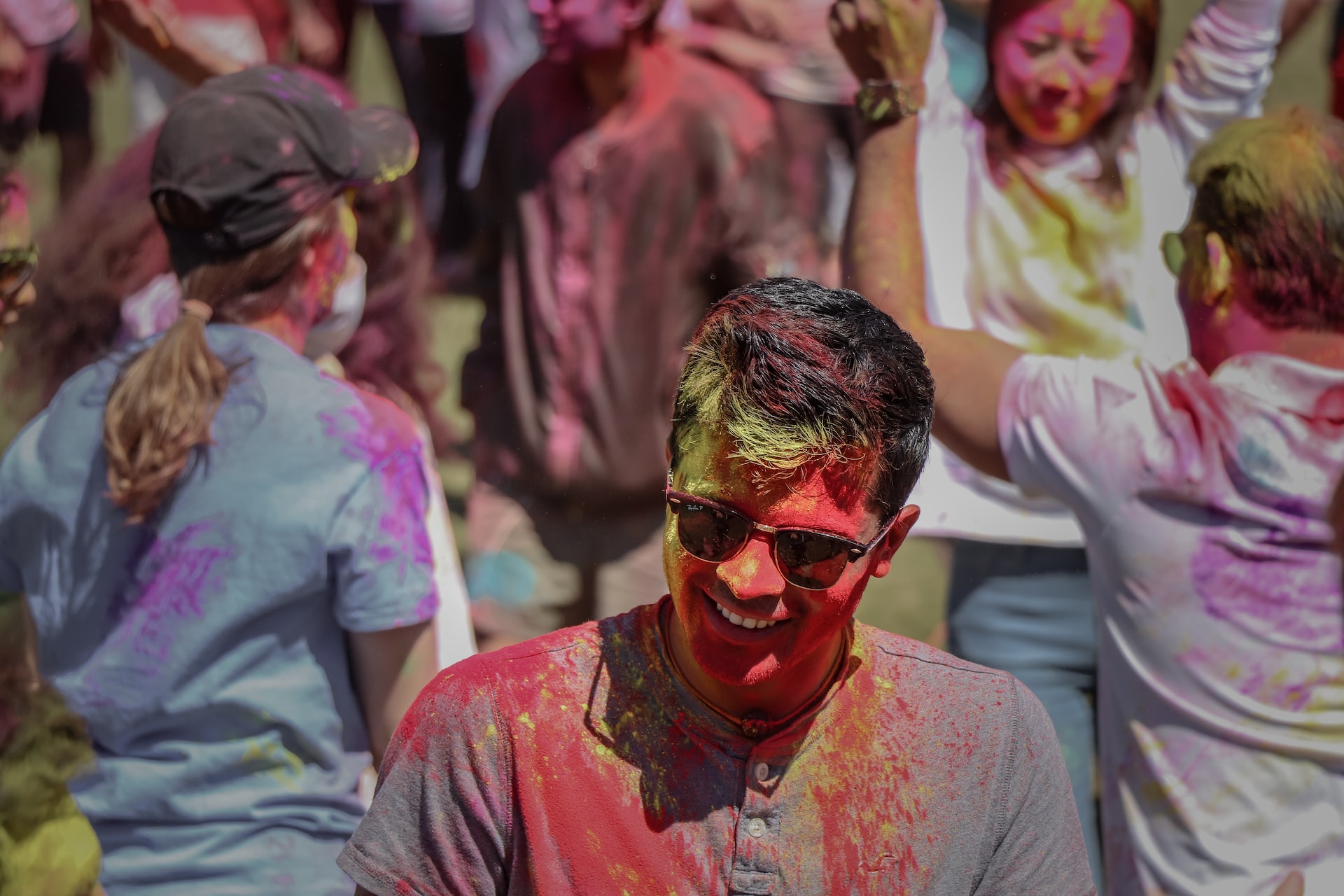 People covered in colorful powder.