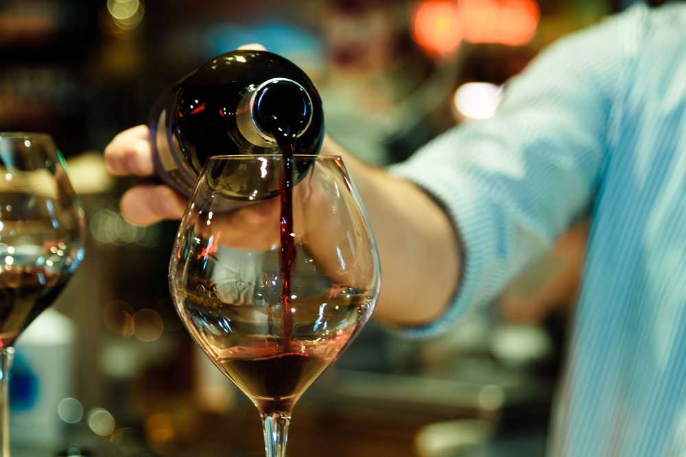 Red wine pouring into a wine glass.