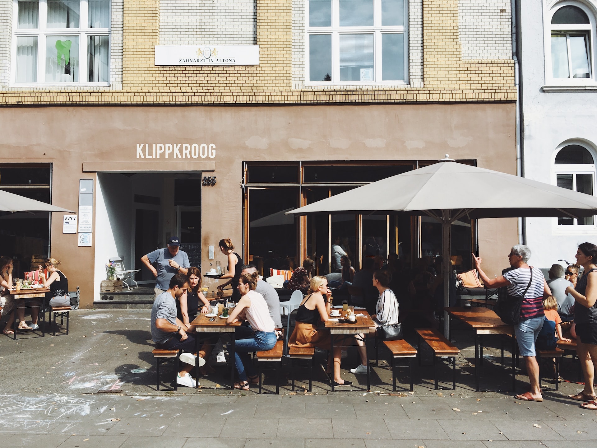 People sitting outside of a coffee shop in Germany.