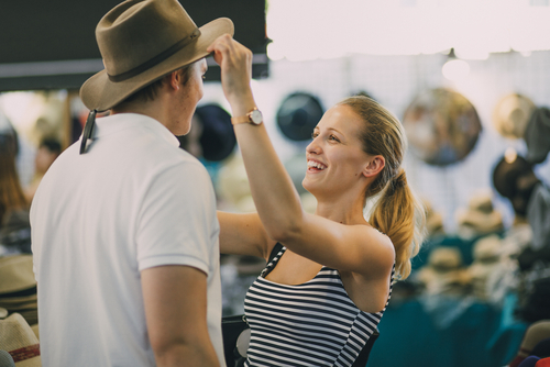 man-trying-on-hat