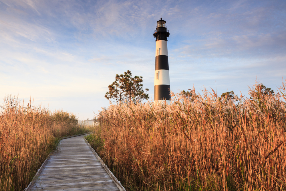 Wooden boardwalk leading through the marsh to the Bodie Island Lighthouse on the Cape Hatteras National Seashore.