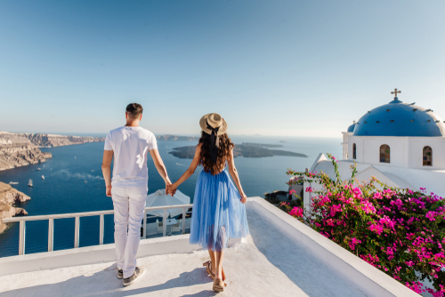 couple-overlooking-water-in-greece