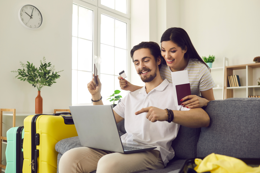 A couple booking a flight holding passports.