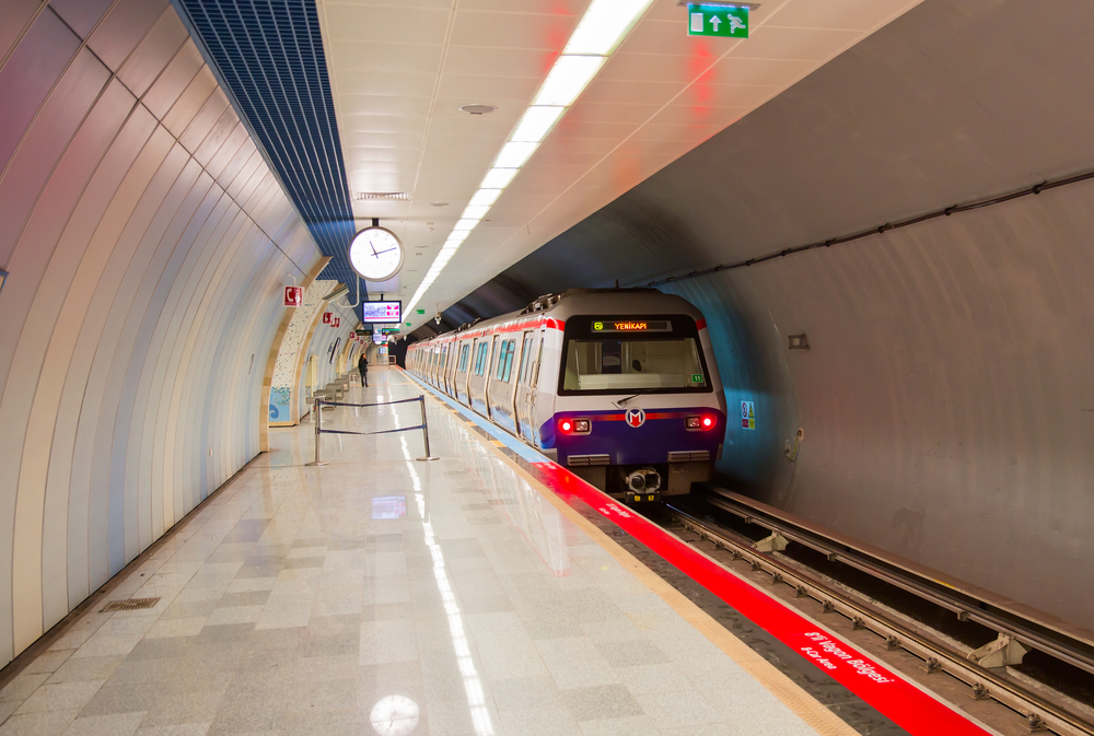 A commuter train arriving in a modern-looking station in Istanbul.