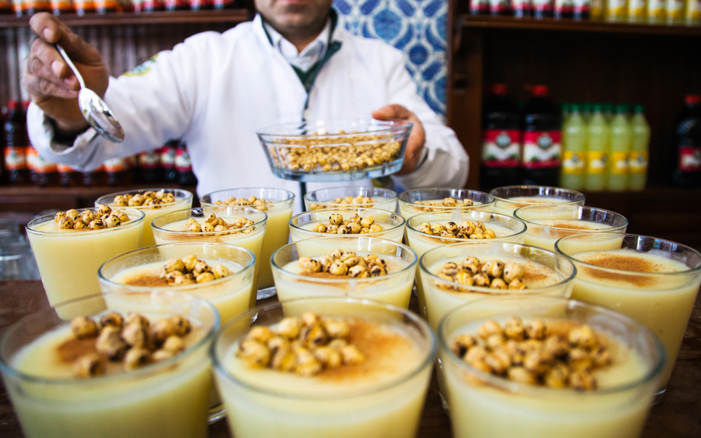 A man behind a bar serving Turkish cuisine.